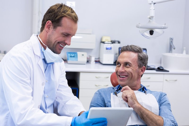 A patient consulting his dentist about dental bridges and partial dentures
